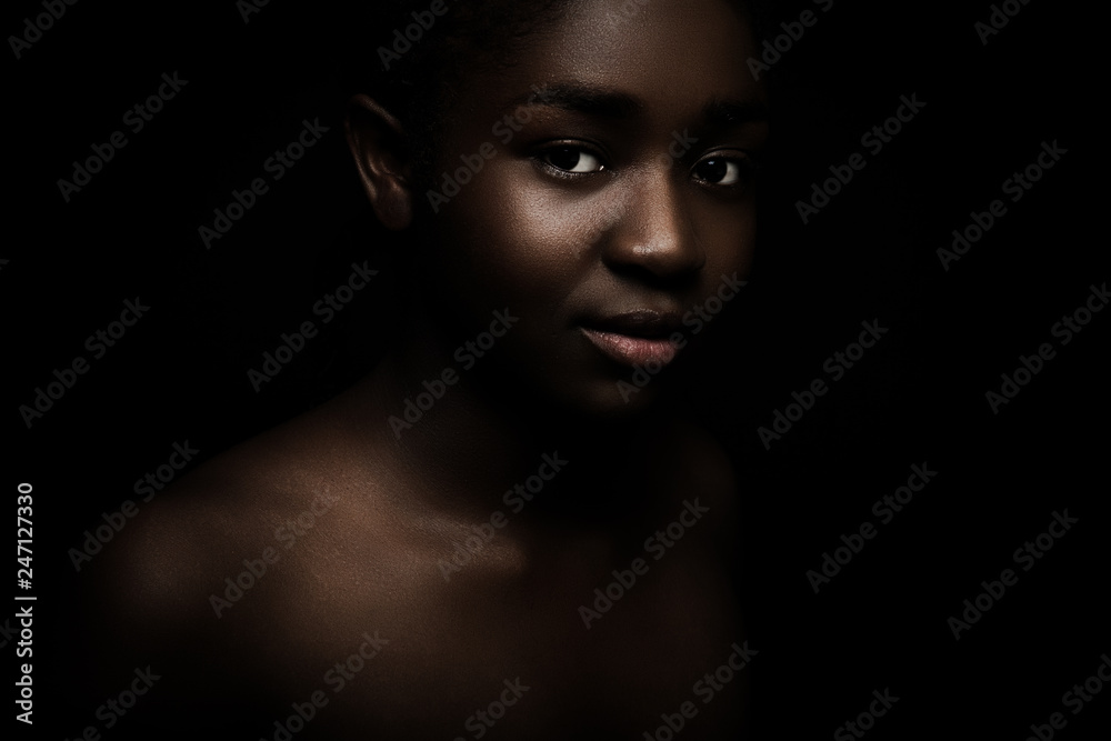 Natural dark portrait of beautiful african woman on black bakground Natural dark portrait of beautiful african woman on black bakground