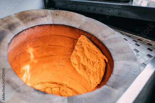 Traditional turkish wood fired stone brick oven and pita or pide bread dough. This stone oven for Turkish pide or pita bread. Also known as Tandır or Tandir photo