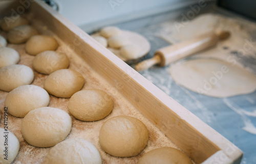 Rolling pin, doughs and flour in kitchen or bakehouse