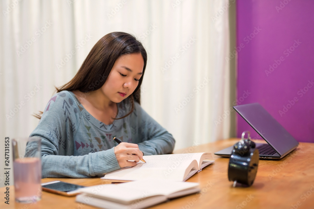 Asian female university student read  book