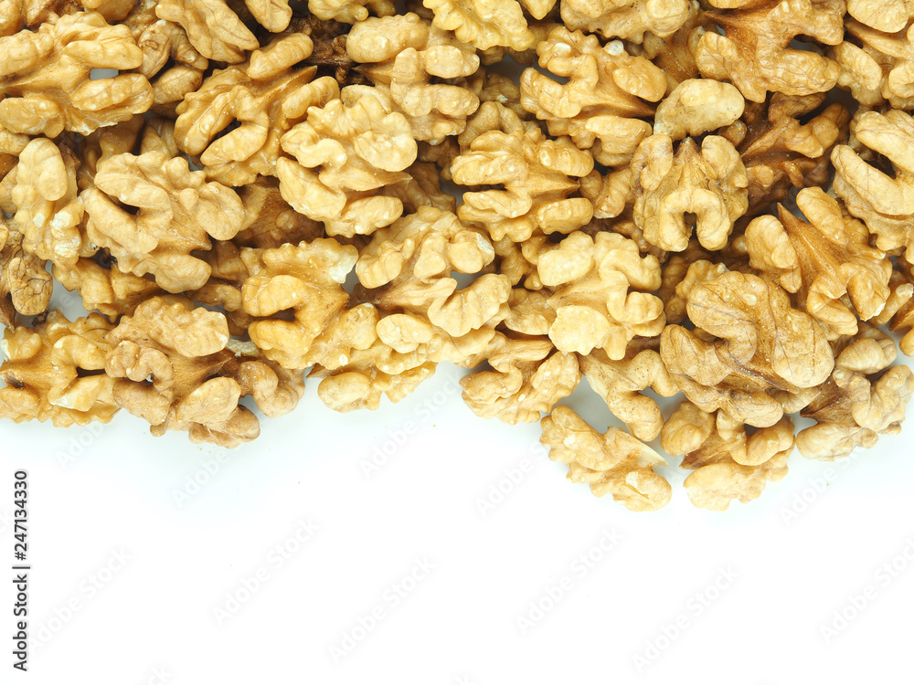 Walnuts as a background and texture on a white background Walnuts as a background and texture on a white background