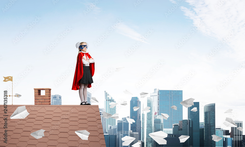 Girl power concept with kid wearing cape and mask and playing guardian. Mixed media Girl power concept with kid wearing cape and mask and playing guardian. Mixed media