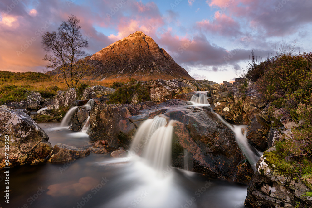 Fototapeta premium Beautiful Waterfall At Buachaille Etive Mor In The Scottish Highlands At Sunrise.