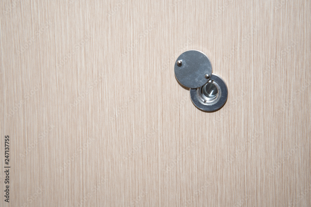 Lens peephole on new light wooden door Lens peephole on new light wooden door