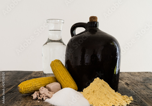 Photos moonshine demi jug and ingredients on rustic wooden table