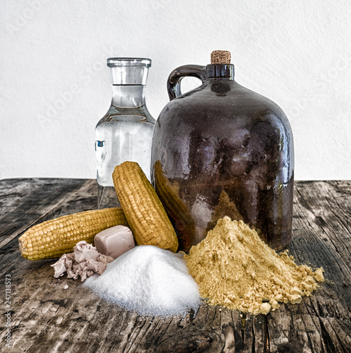 moonshine demi jug and ingredients on rustic wooden table photo