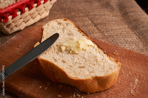 Bakery - gold rustic crusty loaves of bread and buns on black chalkboard background. Still life captured from above