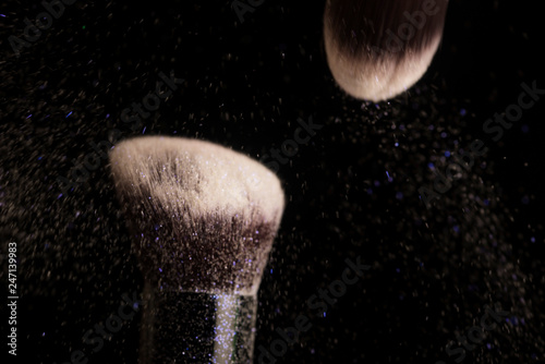 Cosmetics brush and colorful makeup powder