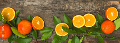 fresh, juicy oranges and blood oranges lie on an old wooden background