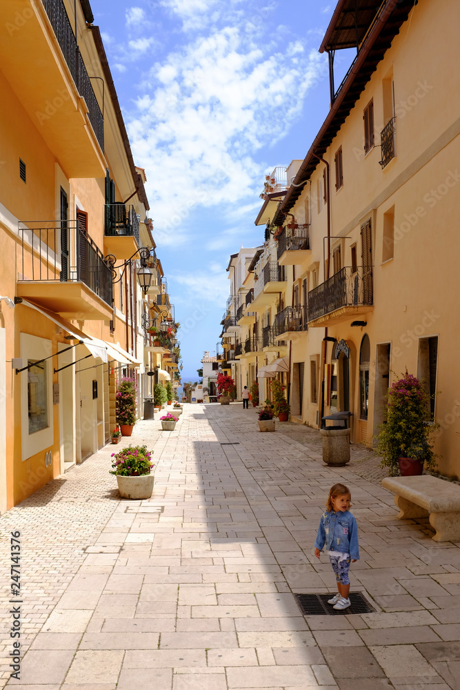 A little girl standing in the picturesque Italian village. San Felice Circeo, Lazio, Italy