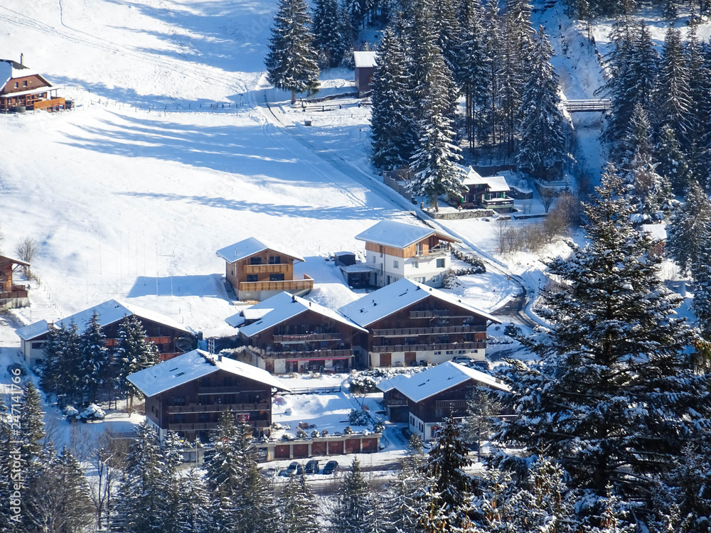 view on typical wooden houses in Swiss Alps near Schwarzsee lake, winter hike from Schwarzsee to Fuchses Schwyberg, Fribourg (Freiburg) canton, Switzerland, Europe view on typical wooden houses in Swiss Alps near Schwarzsee lake, winter hike from Schwarzsee to Fuchses Schwyberg, Fribourg (Freiburg) canton, Switzerland, Europe