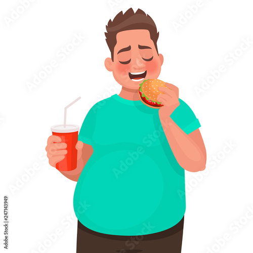 Overweight man eats fast food. Concept of improper food and unhealthy lifestyle