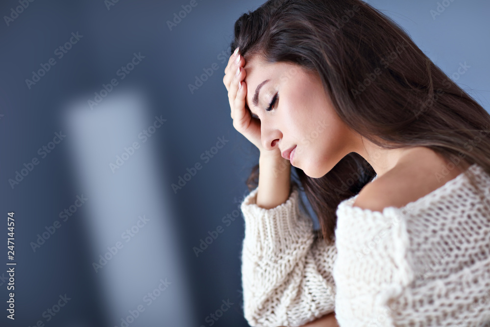 Adult woman suffering from headache at home Adult woman suffering from headache at home