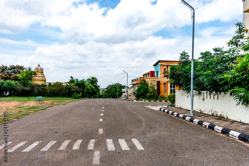 Road crossing in a colony at indian society looking awesome with gardening &  blue sky. 