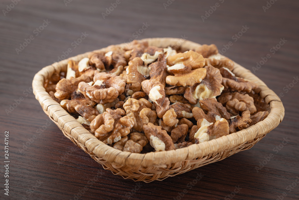 Fresh peeled walnuts in a rattan basket Fresh peeled walnuts in a rattan basket