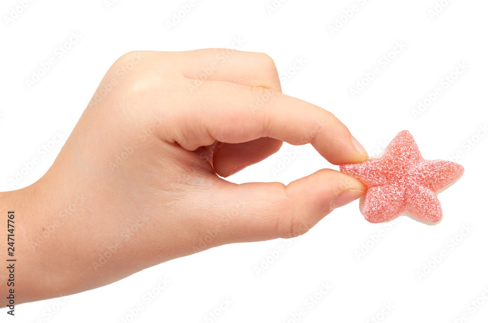 Kids hand with colored star shape candy, sugar lollipop Kids hand with colored star shape candy, sugar lollipop