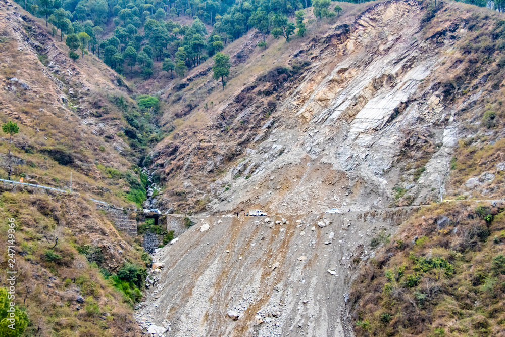 Landslides and rockfalls on the road in the mountains.