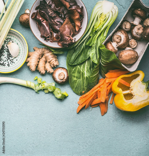 Various traditional asian ingredients for tasty vegetarian cooking : mushrooms , vegetables and spices, top view, flat lay. Chinese or Thai cuisine. Vegan food. Healthy nutrition concept.