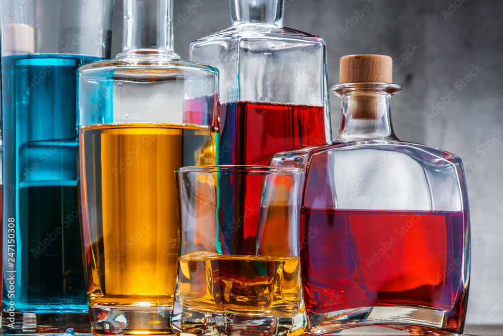 Carafe and bottles of assorted alcoholic beverages.