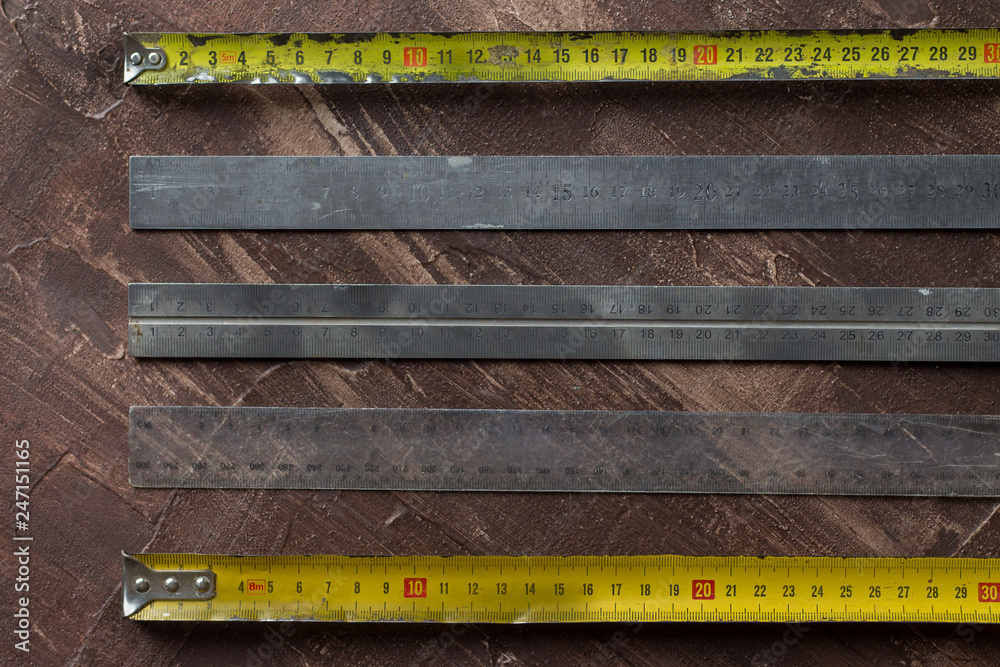 various used tapes, rulers and measures on a rustic backgrond 