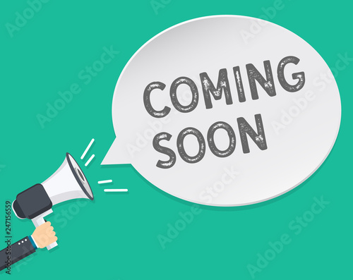 Hand holding megaphone with Coming soon text. Hand holding megaphone with open space for your text.