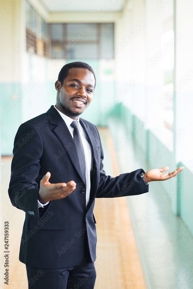 African manager owner ceo business man standing confidently with financial building in africa