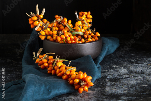 Ripe orange berry, sea buckthorn. Vitamins. Dark background