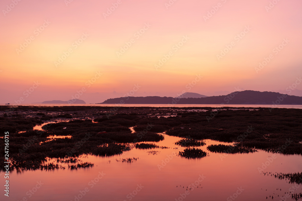 Dramatic sky seascape with coral reefs in sunrise scenery and beautiful reflection in the sea