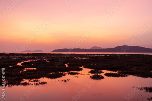 Dramatic sky seascape with coral reefs in sunrise scenery and beautiful reflection in the sea