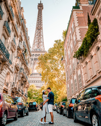 street view with eiffel tower in the midle during summer time in Paris France, couple men and woman walking under Eiffel tower Paris © Fokke Baarssen