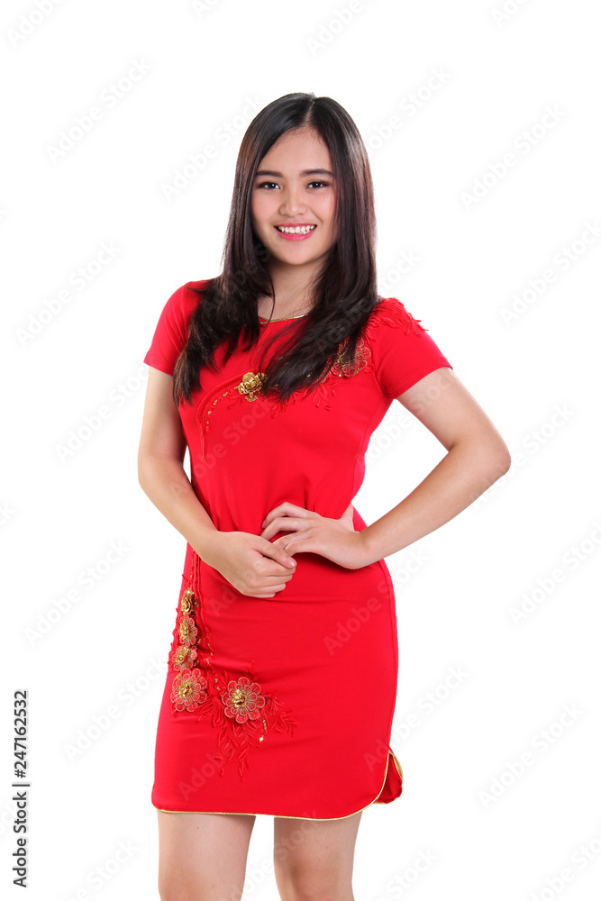 Beautiful Cheongsam model standing over studio background Beautiful Cheongsam model standing over studio background