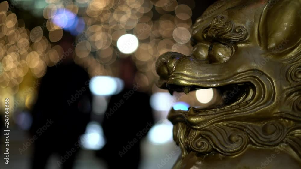 Chinese, Imperial guardian lions. Lion, foo dogs. Traditional Chinese architectural ornament. Stone lions, shishi. On the street of Europa. European Town. People pass behind. Christmas street. Chinese, Imperial guardian lions. Lion, foo dogs. Traditional Chinese architectural ornament. Stone lions, shishi. On the street of Europa. European Town. People pass behind. Christmas street.