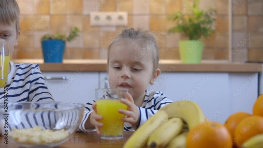 Boy and girl drinking a glass of fresh orange juice Boy and girl drinking a glass of fresh orange juice
