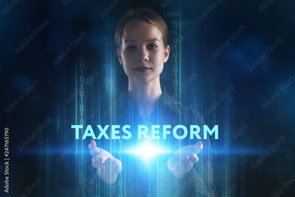 The concept of business, technology, the Internet and the network. A young entrepreneur working on a virtual screen of the future and sees the inscription: taxes reform The concept of business, technology, the Internet and the network. A young entrepreneur working on a virtual screen of the future and sees the inscription: taxes reform