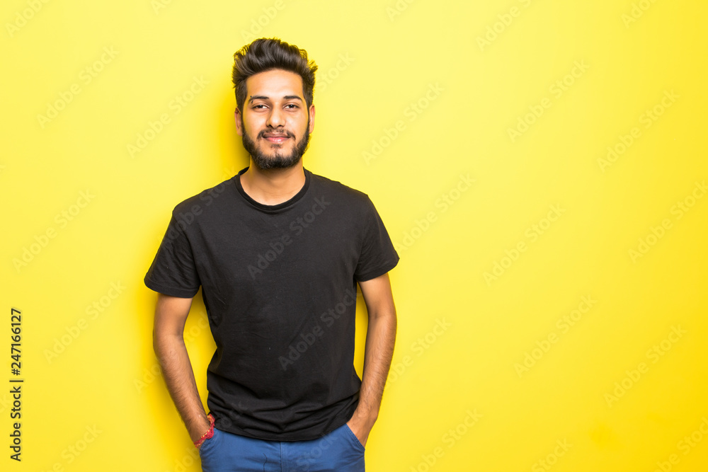 Indian bearded man standing isolated on yellow background Indian bearded man standing isolated on yellow background