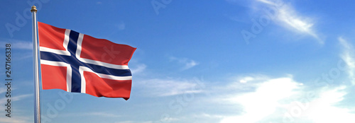 Flag of Norway rise waving to the wind with sky in the background photo