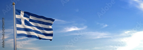 Flag of Greece rise waving to the wind with sky in the background photo