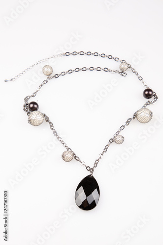 glamour fashion necklace homemade jewelry black stone under white background