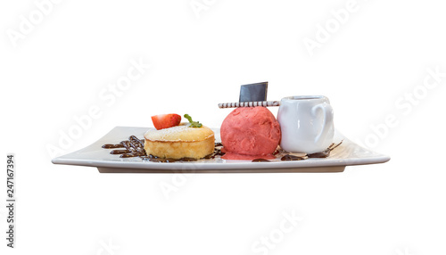 Side view of white chocolate lava cake served with strawberry ice-cream and sauce isolated on white background.