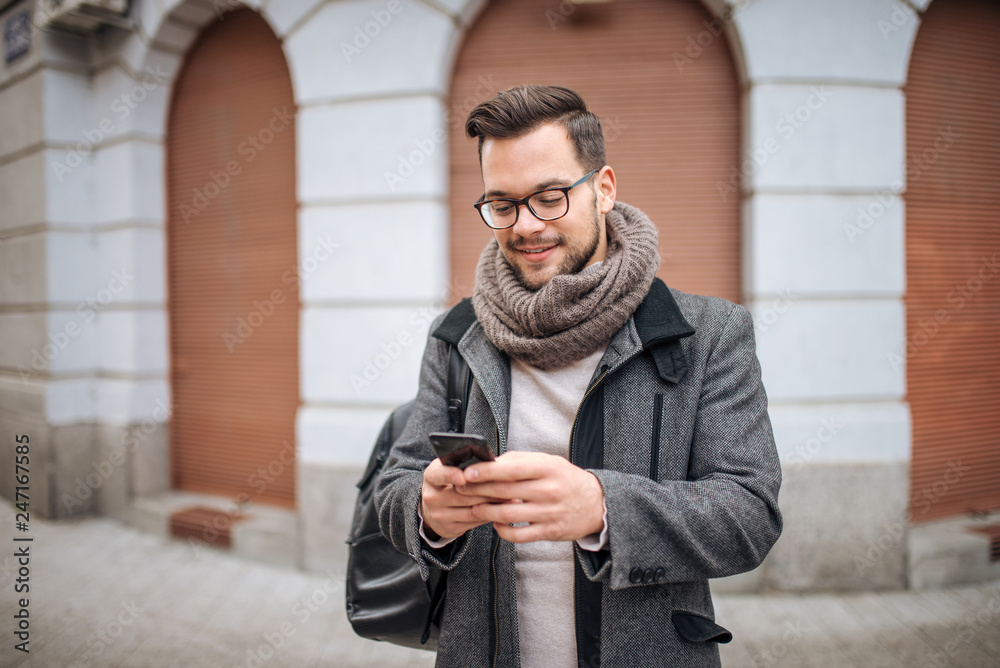Hipster man walking in the city and typing sms. Hipster man walking in the city and typing sms.