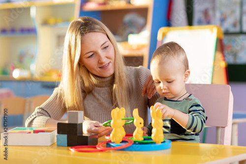 Nursery baby and carer play...