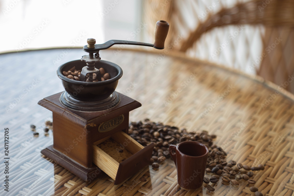 coffee grinder with roasted coffee beans on the table