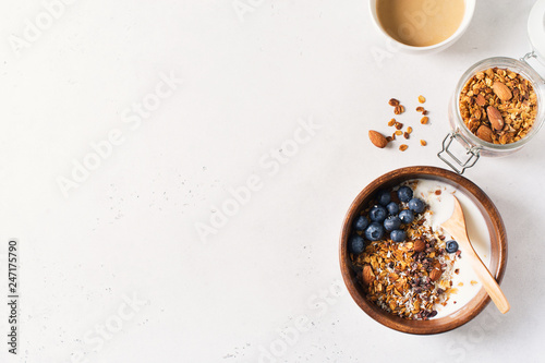 Homemade granola muesli with blueberries and coffee on white background breakfast