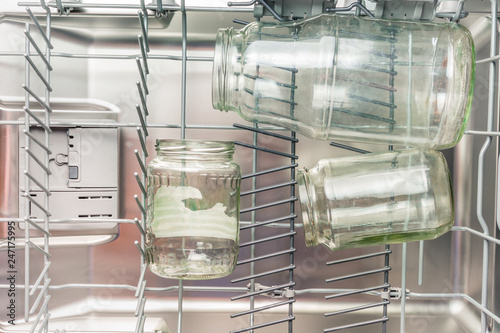 Glass jars are loaded in the lower compartment of the dishwasher