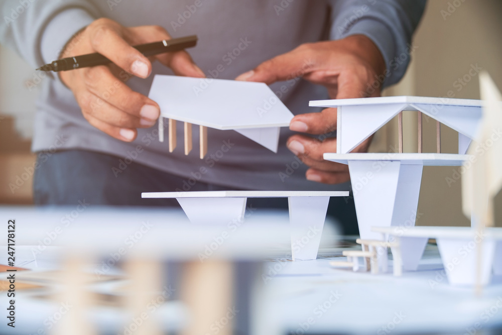 © Chaosamran_Studio - architect design working drawing sketch plans blueprints and making architectural construction model in architect studio
