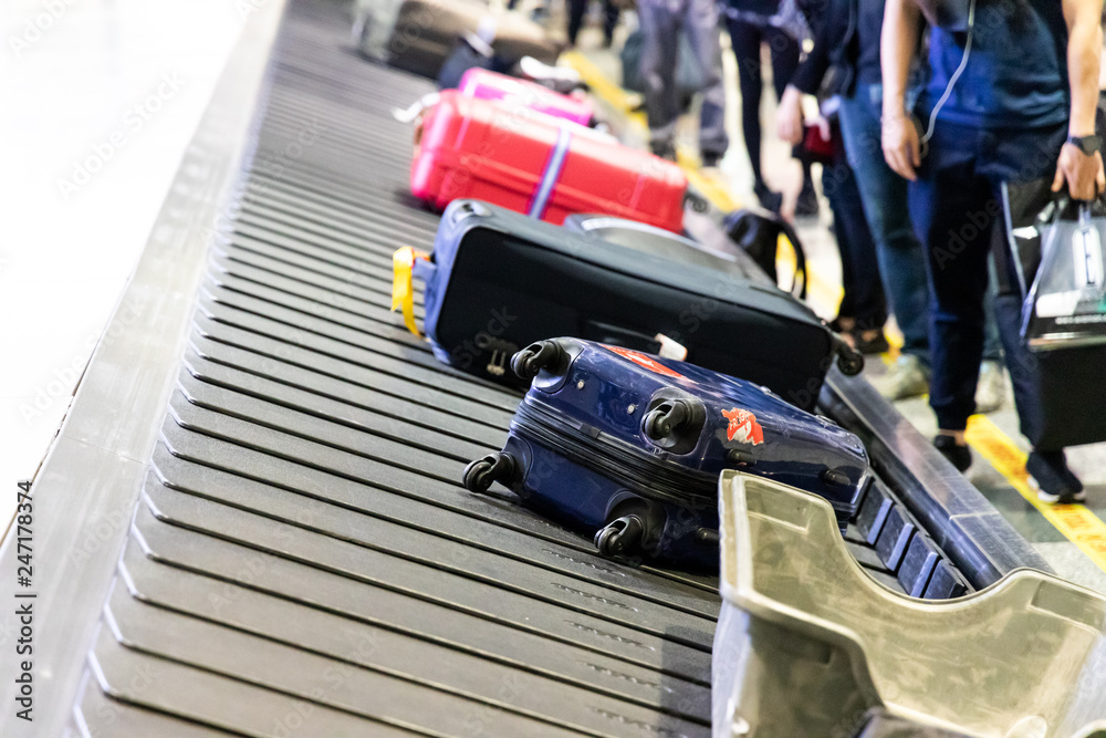 Fototapeta premium Baggage luggage on conveyor carousel belt at airport arrival