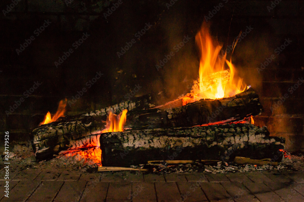 A glowing fire in the stone fireplace A glowing fire in the stone fireplace