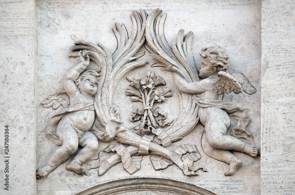 Angels with symbols of martyrdom on the portal of Sant Andrea della Valle Church in Rome, Italy