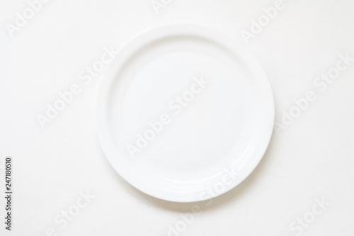 Porcelain tableware. China art. Empty round plate mockup on white background. Flat lay.