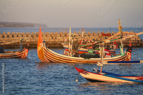 Colorful handcrafted Balinese wooden fishing boat at port in Jimbaran beach, Bali photo